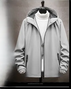 Detailed view of a light gray hooded windbreaker jacket with secure zip pockets.