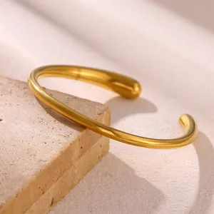 Detailed view of a minimalist 18k gold plated stainless steel open cuff bracelet for women