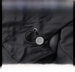 Close-up detail of the adjustable drawstring and toggle on a black jacket collar