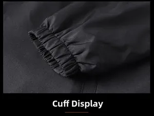 Macro view showing the elastic cuff detail of a black minimalist hooded windbreaker jacket