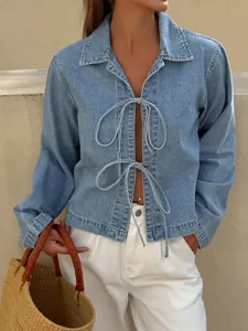 Elegant French style tie-front denim top for women featuring a light blue wash