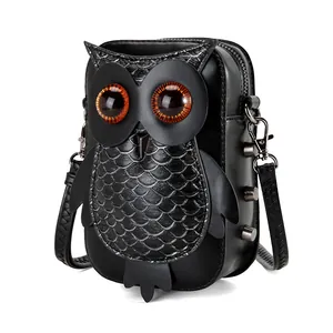 Unique punk style black owl shaped crossbody bag with amber eyes and scale detail