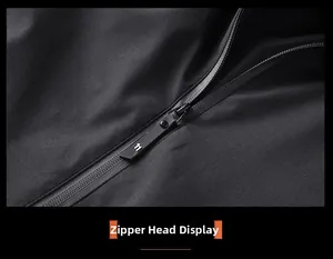 Macro detail of the high-quality waterproof zipper on a black slim fit hooded jacket.