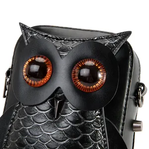 Creative punk owl-shaped black crossbody bag with detailed scale texture and amber eyes.