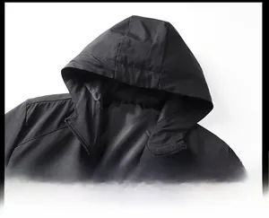Close-up macro detail of a minimalist black hooded jacket showing hood and collar.