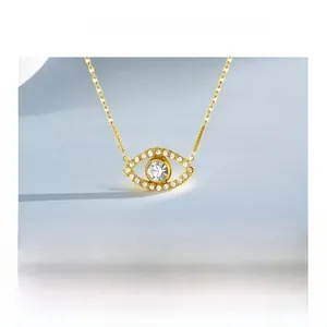 Detail view of the vintage Evil Eye necklace pendant with sparkling crystal and gold plating