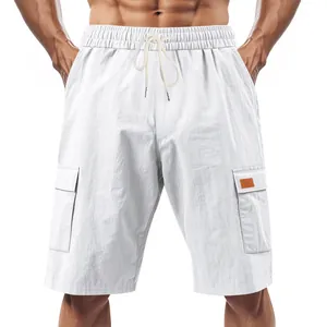 Detail of white breathable linen cargo shorts for men with pockets and drawstring.