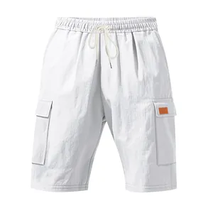 Detail view of men's white breathable linen cargo shorts with drawstring waist design.