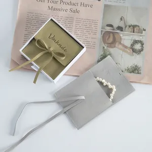 Premium microfiber jewelry pouch set with elegant ribbon and pearl necklace display