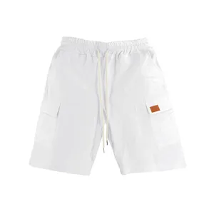 Detail view of breathable white linen cargo shorts with drawstring waist and pockets
