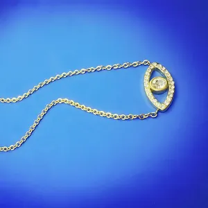 Detailed close-up view of a gold-plated evil eye necklace with sparkling crystal accents