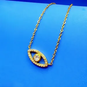 Vintage gold-plated evil eye pendant necklace detail with sparkling clear crystals