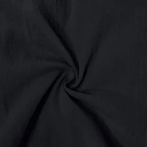 Close-up of black breathable linen fabric texture for men's casual shorts