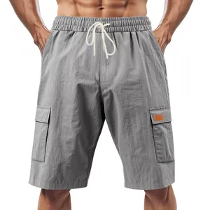 Detailed view of grey men's cargo shorts with elastic drawstring and side pockets