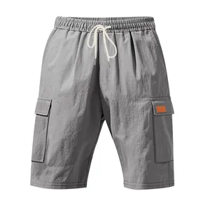 Macro detail view of grey men's linen cargo shorts with elastic waist and pockets