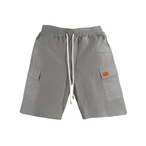 Detailed macro view of grey linen cargo shorts with adjustable elastic drawstring waist