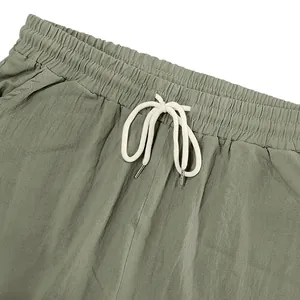 Detailed close-up of men's linen shorts waistband with white adjustable drawstring