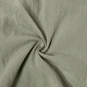 Detailed macro view of breathable sage green linen fabric texture for men's shorts