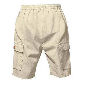 Back view of men's loose beige linen cargo shorts featuring side pockets and elastic waist.