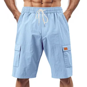 Close-up showing the texture and drawstring of light blue linen cargo shorts for men.