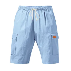 Detail of light blue linen cargo shorts with elastic drawstring waist and pockets