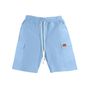 Detailed view of light blue linen cargo shorts with drawstring waist and side pockets.