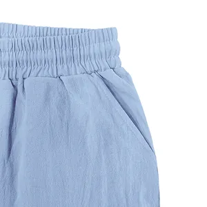 Detail view of light blue linen shorts featuring elastic waist and side pocket