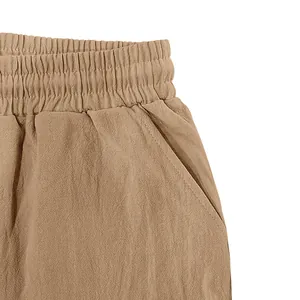 Detailed close-up of elastic waistband and side pocket on men's khaki linen shorts
