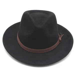 Close-up of black wool fedora hat with a brown suede band and tassel detail.