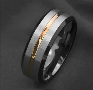 Detailed macro view of a brushed titanium steel ring with black edges and gold stripe