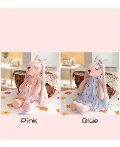 Detailed comparison of pink and blue long-eared bunny plush toys wearing floral dresses