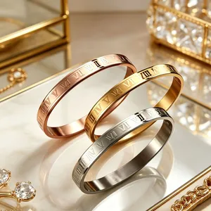 Set of three 8mm wide stainless steel bangles with Roman numeral engravings in gold