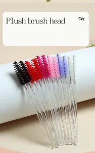 Detailed view of disposable eyelash brushes with glitter crystal handles and spiral heads