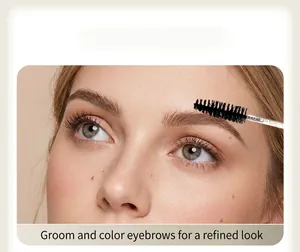 Detail shot of a disposable spiral eyelash and eyebrow brush grooming a model's eyebrows