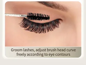 Macro view of crystal handle disposable eyelash brush combing through thick false lashes