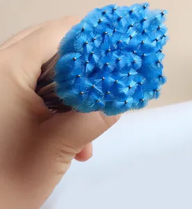 Detailed macro shot of blue disposable mascara wands with dense spiral nylon bristles
