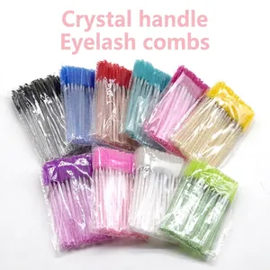 Disposable colorful eyelash brushes with glitter crystal handles set on white background