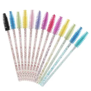 Set of disposable mascara brushes with colorful heads and glittery crystal handles