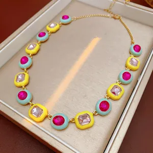 Vintage style enamel necklace with pink zircon crystals in yellow and mint links