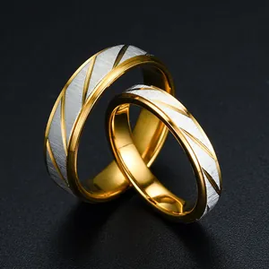 Macro close-up of golden couple rings featuring brushed silver diagonal line texture