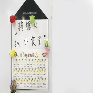 Detail view of creative 3D ceramic mini plant pot fridge magnets on a memo board