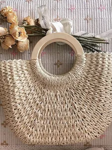 Detailed view of retro straw beach bag with round wooden handles and exquisite weave.