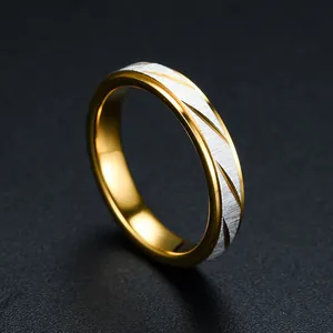 Detailed macro shot of a gold and silver stepped ring with diagonal textured patterns