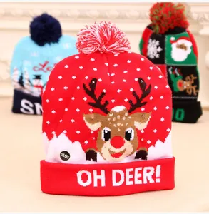Detail of a red LED Christmas beanie featuring a cute reindeer and 'OH DEER!' text.