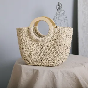 Close-up of vintage straw bag featuring round wooden handles and weave texture