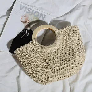 Close-up detail of a retro woven straw beach bag featuring large capacity and round wooden handles