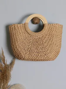 Handmade vintage woven straw handbag with round wooden handles for summer beach vacations