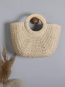 Handmade vintage woven straw handbag with circular wooden handle for beach vacations