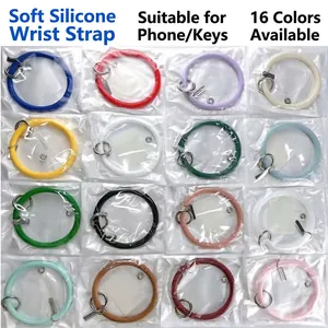 Display of 16 different colored silicone bracelet keychains in individual packaging