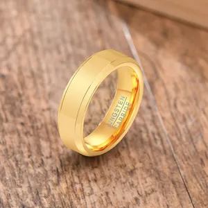 Close-up of gold-plated tungsten carbide men's ring with inner engraving detail.